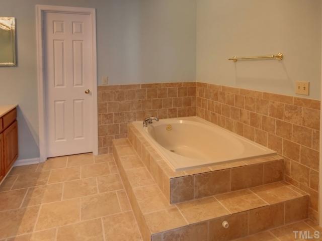 8404 Grey Abbey Place Raleigh, NC 27615 - Photo 9 of 12 Check out this master bathroom. Brand new tile! Large garden tub and separate shower! Dual vanities!