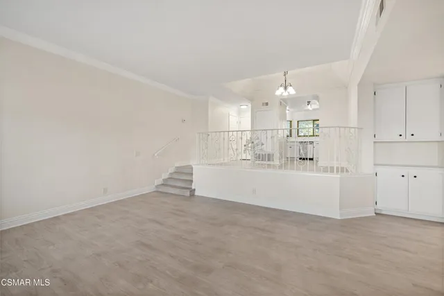 a view of a kitchen with white cabinets and a stove