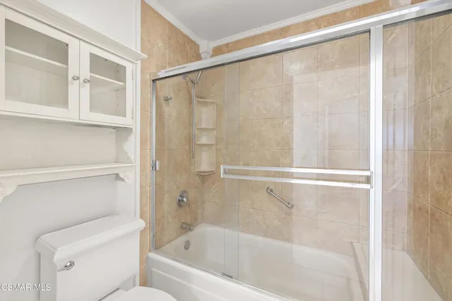 a bathroom with a shower and a toilet