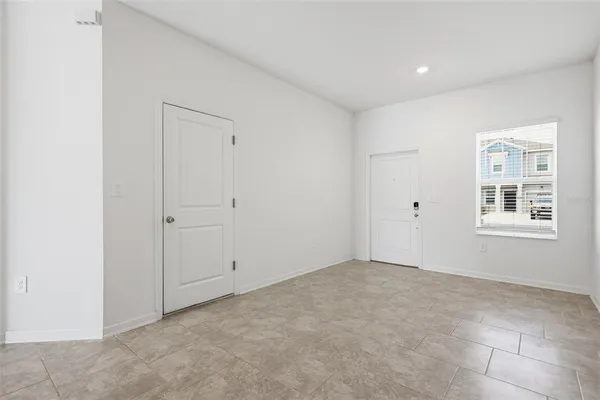 an empty room with cabinet and mirrors