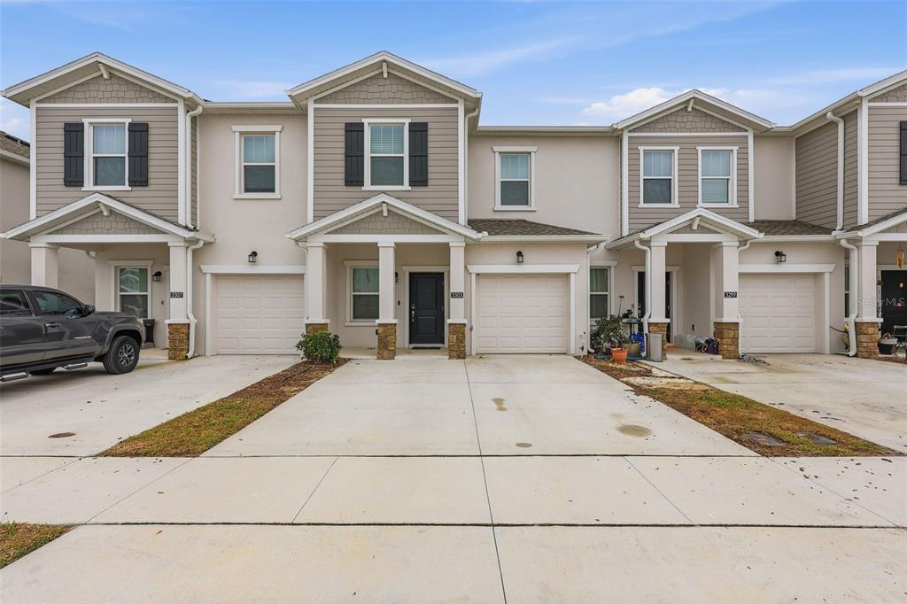 3303 Laurent Loop Davenport, FL 33837 - Photo 2 of 37 a front view of a house with a yard