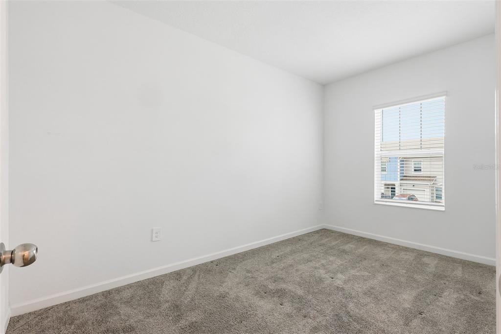 3303 Laurent Loop Davenport, FL 33837 - Photo 21 of 37 an empty room with windows