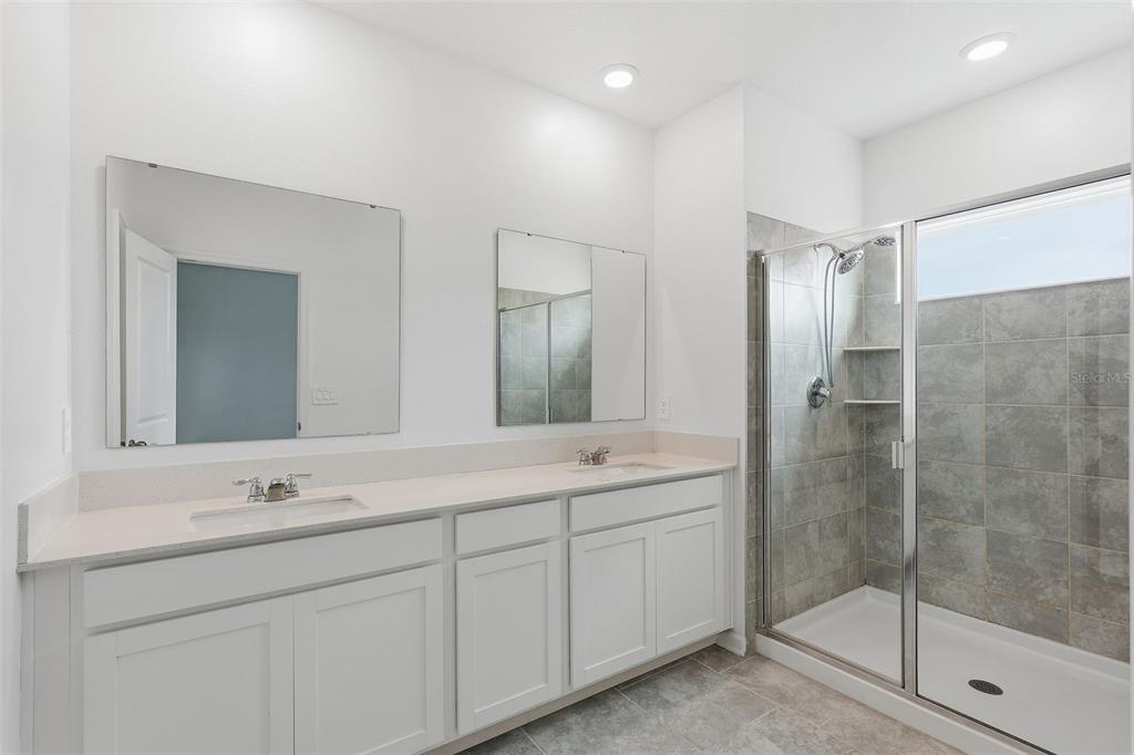 3303 Laurent Loop Davenport, FL 33837 - Photo 29 of 37 a bathroom with a shower sink and mirror