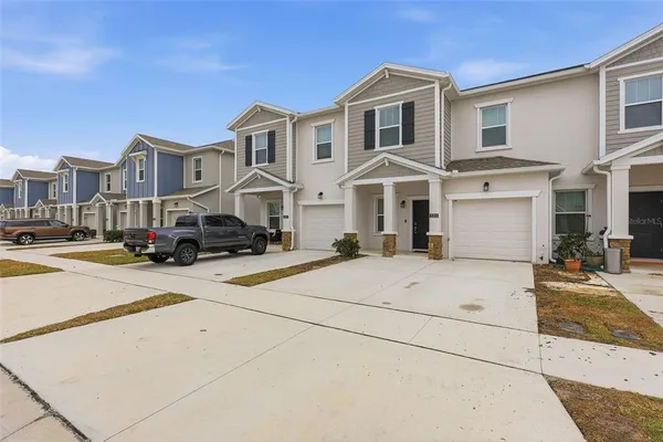 a front view of a building with cars parked