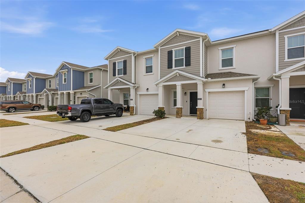 3303 Laurent Loop Davenport, FL 33837 - Photo 3 of 37 a front view of a building with cars parked