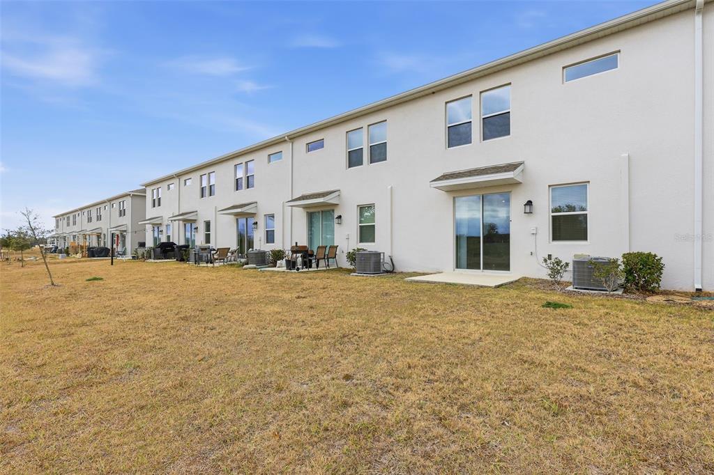 3303 Laurent Loop Davenport, FL 33837 - Photo 34 of 37 a view of a house with backyard and swimming pool