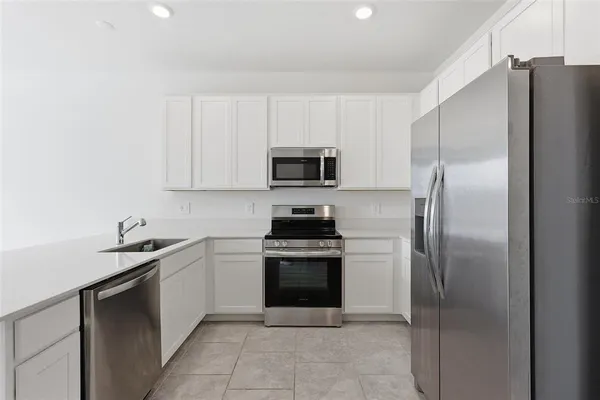 a kitchen with a sink and a stainless steel appliances