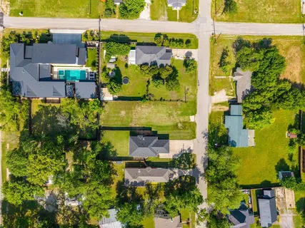 an aerial view of a houses with yard