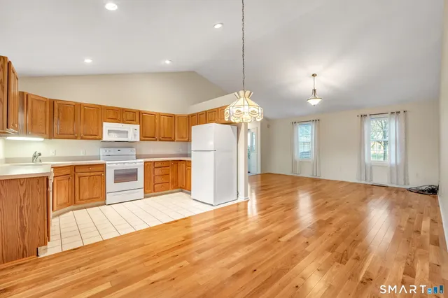 a view of a kitchen with cabinets and wooden floor