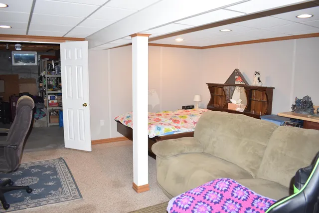 a bedroom with furniture and a painting on the wall