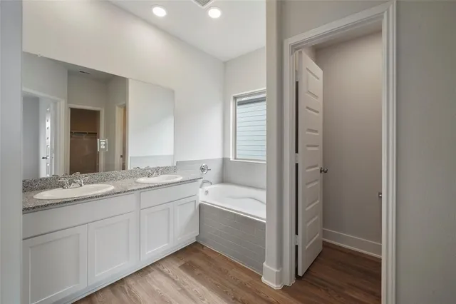 a bathroom with a granite countertop sink mirror and double