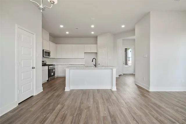 a view of a kitchen with sink stainless steel appliances and cabinets
