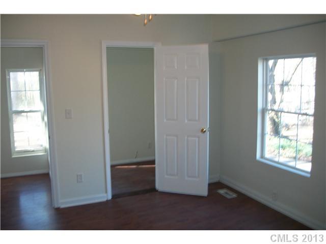 303 Forest Park Road Matthews, NC 28104 - Photo 4 of 13 a view of an empty room with wooden floor and a window