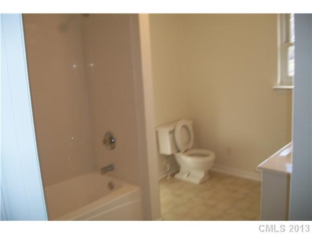 303 Forest Park Road Matthews, NC 28104 - Photo 9 of 13 a bathroom with a bathtub and a sink