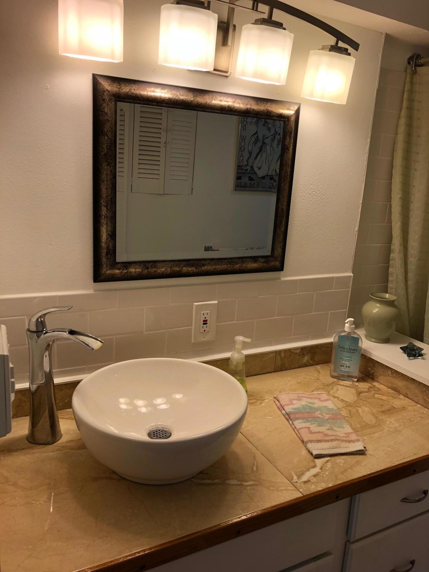349 Sound Drive Key Largo, FL 33037 - Photo 12 of 16 a bathroom with a sink and a mirror