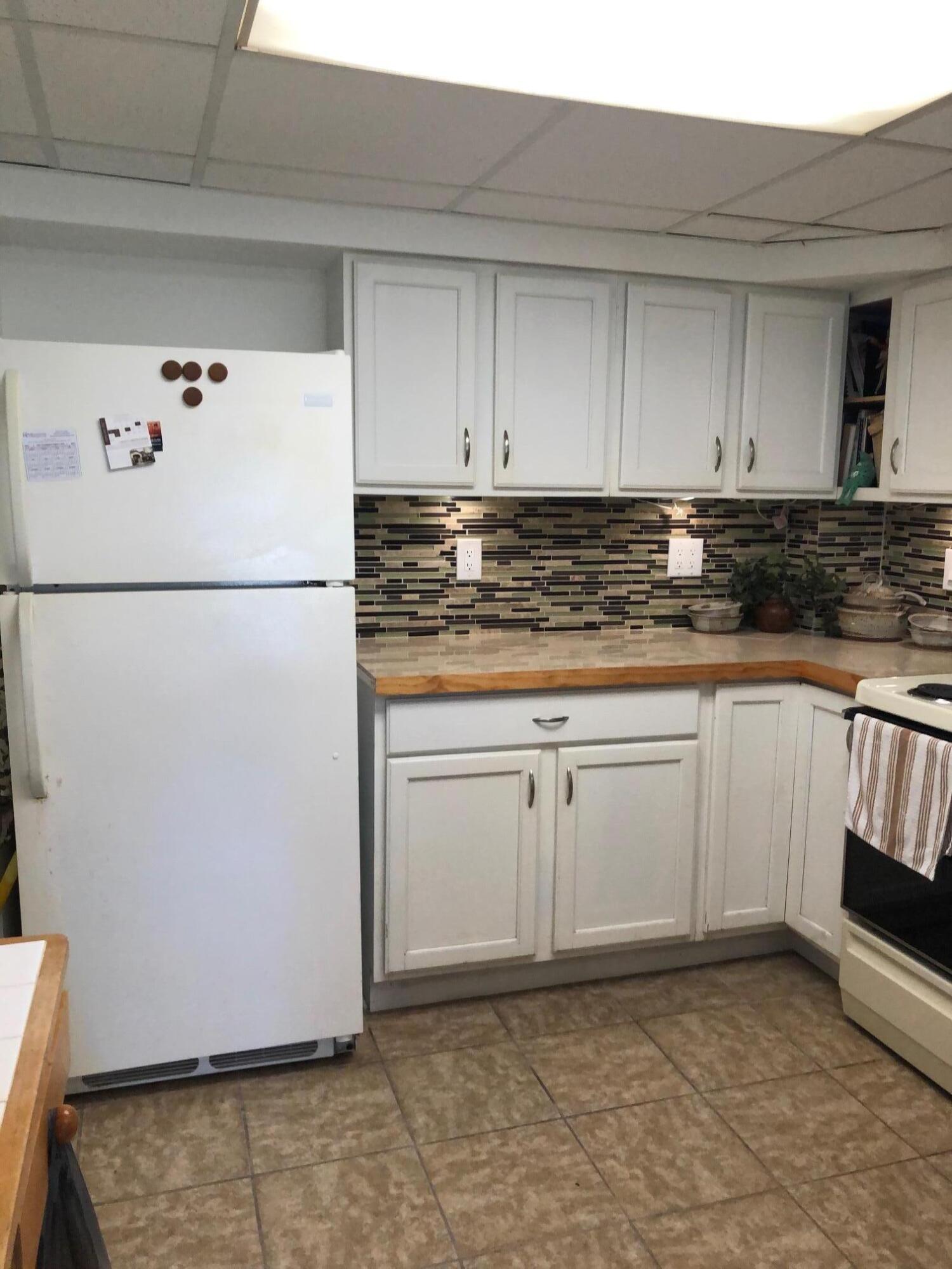 349 Sound Drive Key Largo, FL 33037 - Photo 6 of 16 a white refrigerator freezer sitting inside of a kitchen