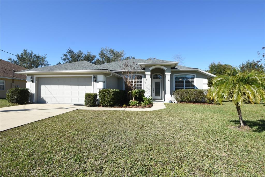 39 Praver Lane Palm Coast, FL 32164 - Photo 1 of 1 a front view of a house with a garden