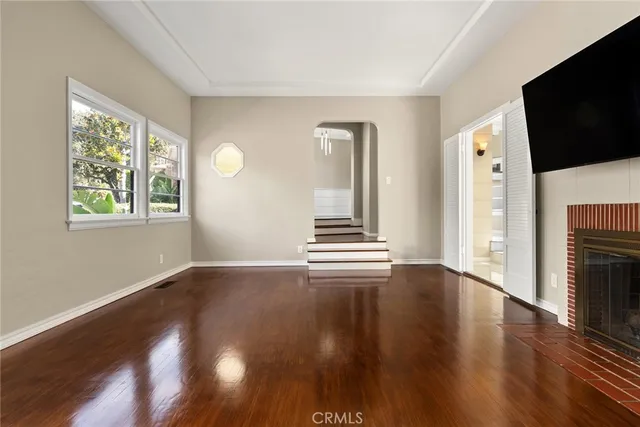 a view of a livingroom with wooden floor and window