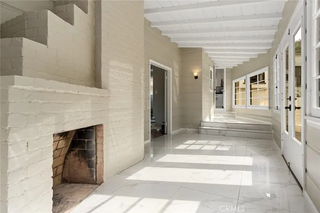 a view of a hallway with toilet and entryway