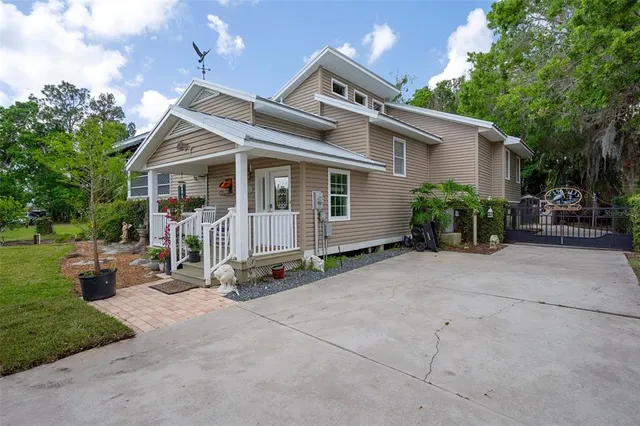 a view of a house with backyard sitting area and garden