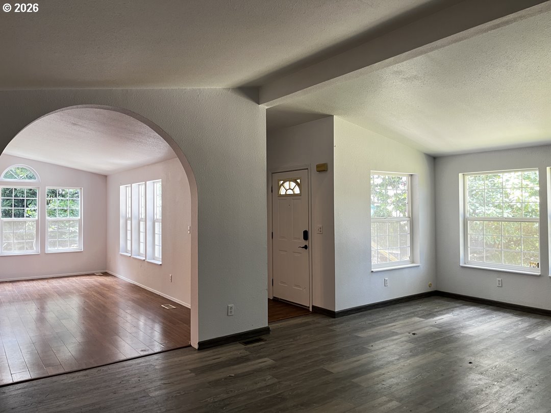 83411 Clear Lake Road Florence, OR 97439 - Photo 21 of 47 an empty room with wooden floor and windows