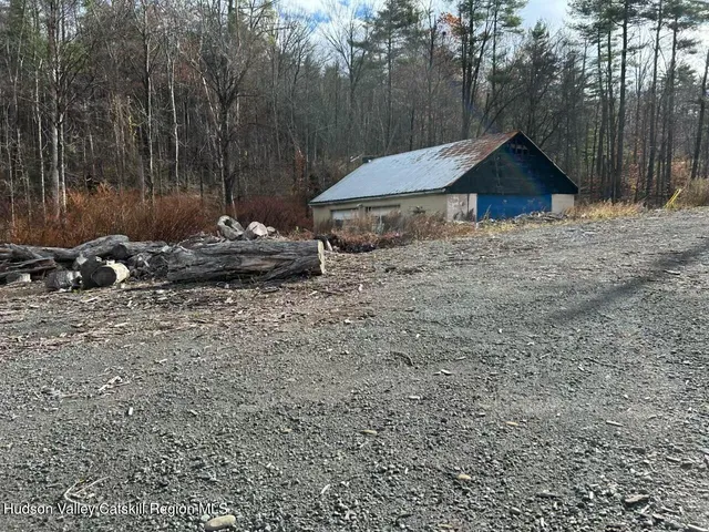 a view of a house with a yard fire pit and outdoor seating