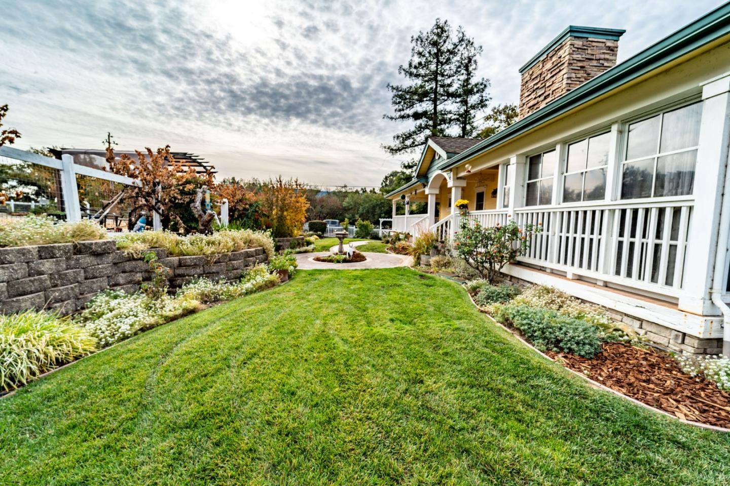 9110 Burchell Road Gilroy, CA 95020 - Photo 18 of 52 a view of a house with backyard sitting area and garden