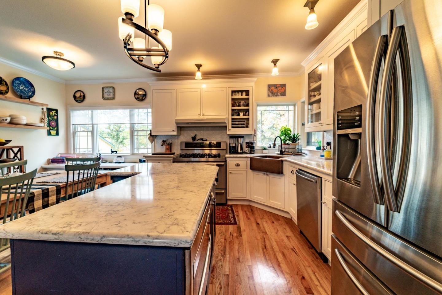 9110 Burchell Road Gilroy, CA 95020 - Photo 31 of 52 a kitchen with stainless steel appliances granite countertop a refrigerator a stove top oven a sink dishwasher and white cabinets with wooden floor
