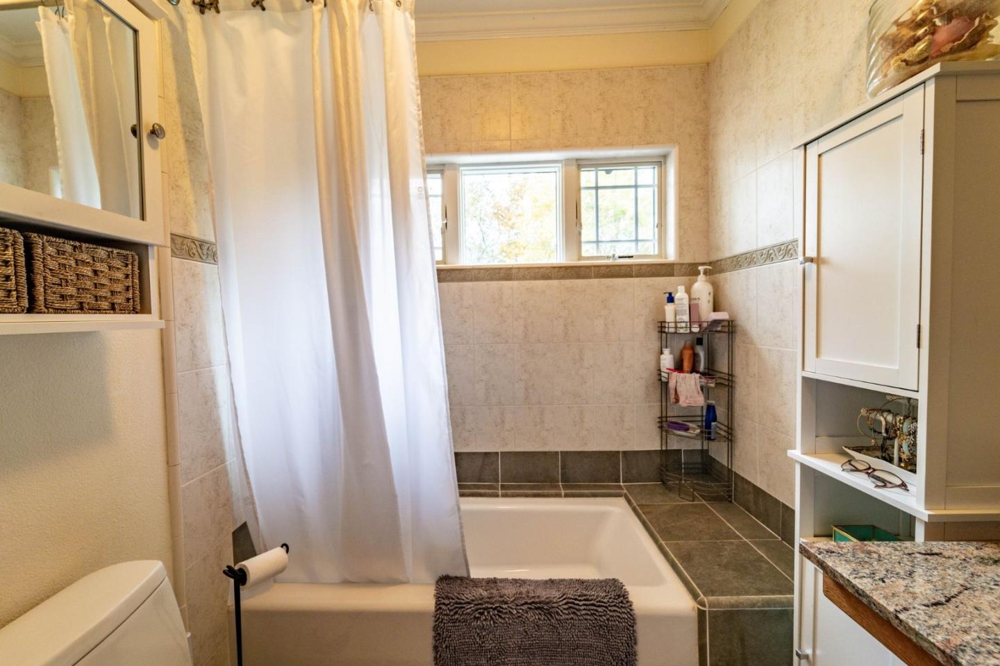 9110 Burchell Road Gilroy, CA 95020 - Photo 41 of 52 a bathroom with a granite countertop sink and a mirror