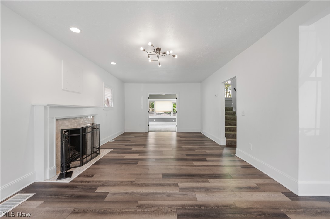 371 Merriman Road Akron, OH 44303 - Photo 4 of 27 Spacious room featuring wood-finish flooring, a decorative fireplace with a mantel, recessed lighting, and a contemporary ceiling fixture