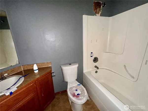 a bathroom with a bath tub and a toilet