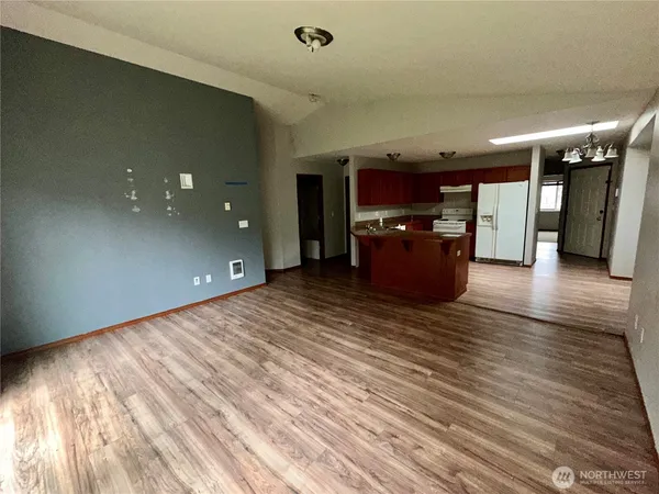 a view of a living room with furniture and wooden floor