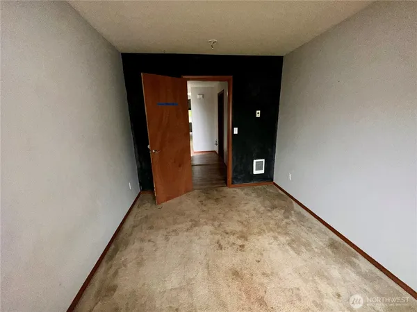 a view of a hallway with wooden shelves