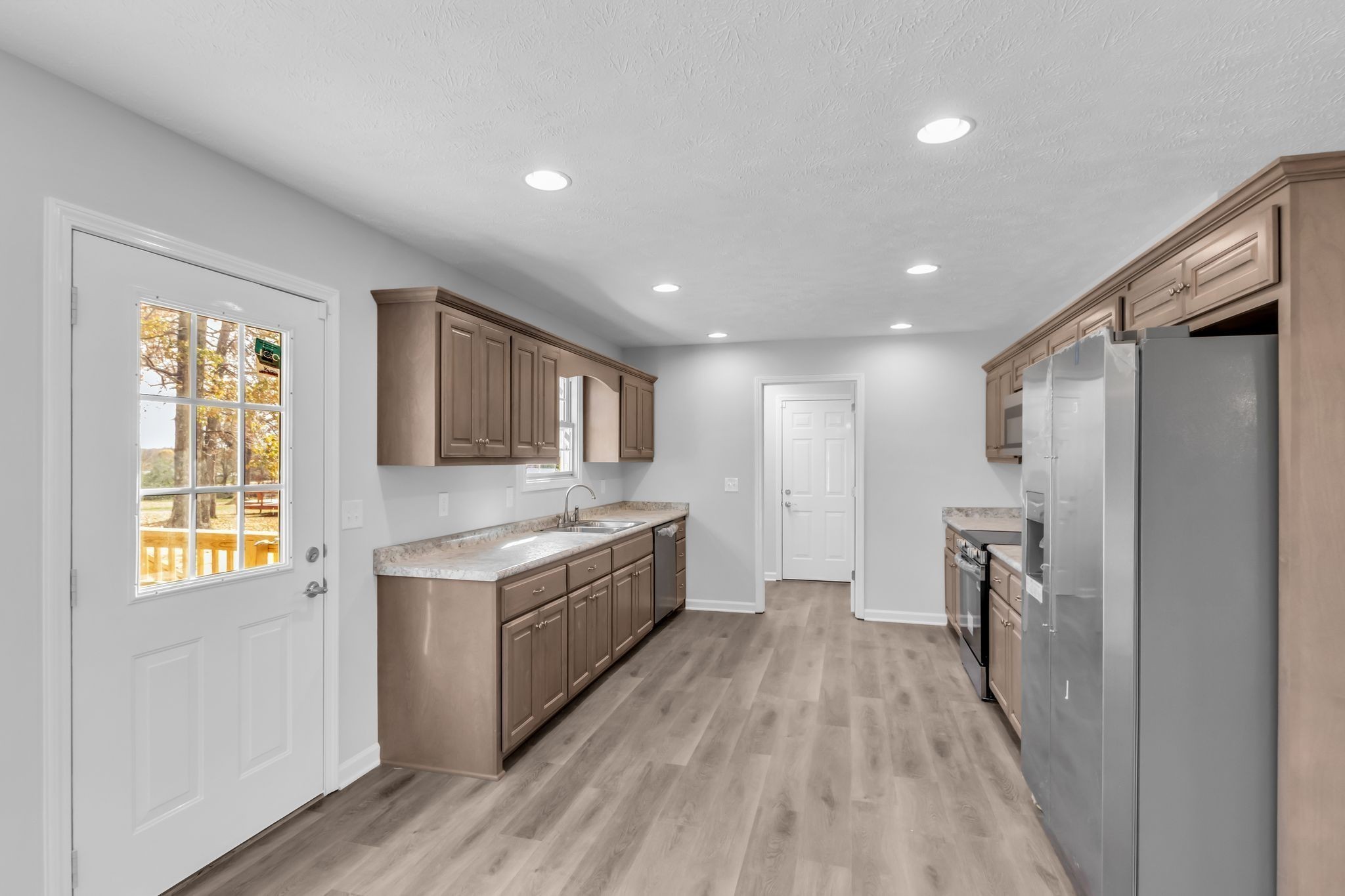 769 Old Bushy Branch Road Manchester, TN 37355 - Photo 6 of 24 a view of a kitchen with a sink and a refrigerator