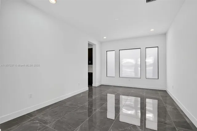 a kitchen with stainless steel appliances a refrigerator and a stove top oven