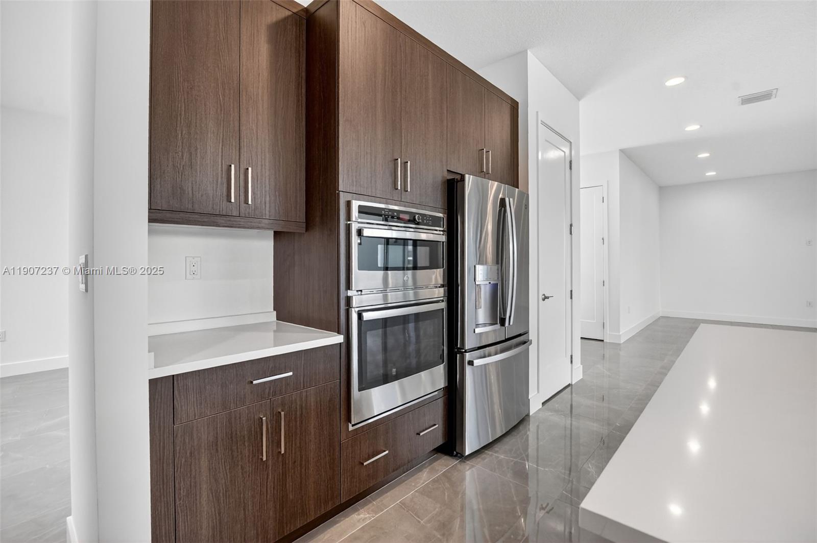 8215 Crystal Downs Avenue, Unit 8215 Boca Raton, FL 33434 - Photo 25 of 95 a kitchen with stainless steel appliances a refrigerator and a stove top oven