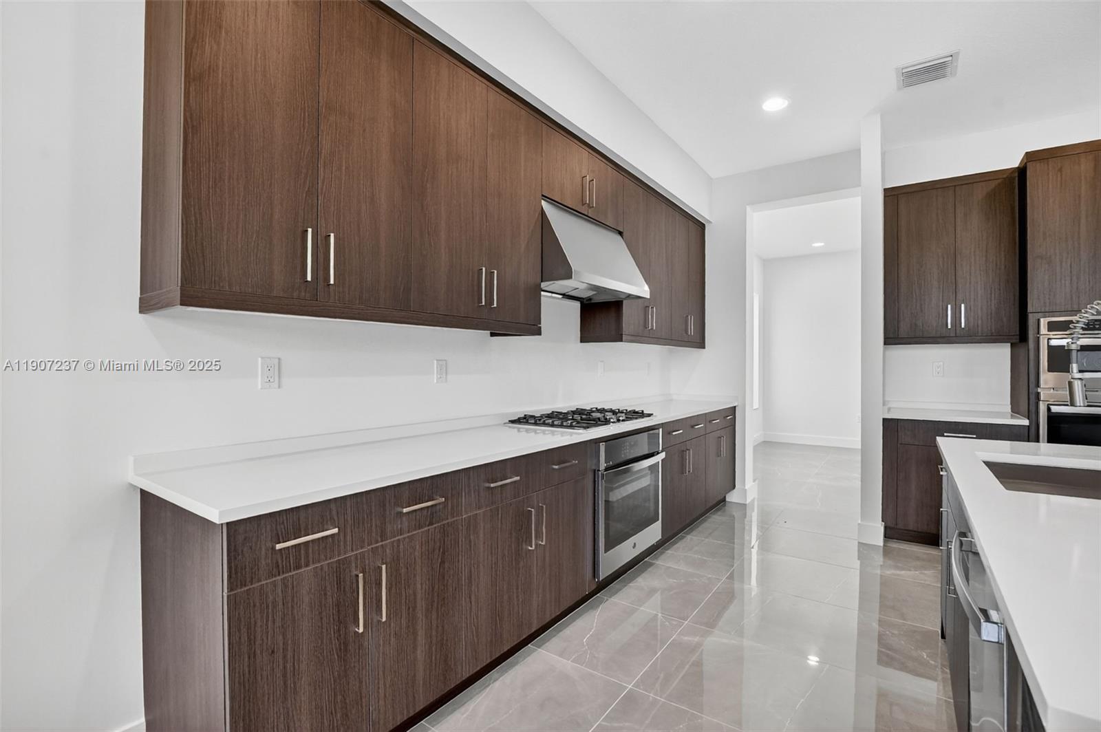 8215 Crystal Downs Avenue, Unit 8215 Boca Raton, FL 33434 - Photo 27 of 95 a kitchen with stainless steel appliances granite countertop a sink stove and refrigerator