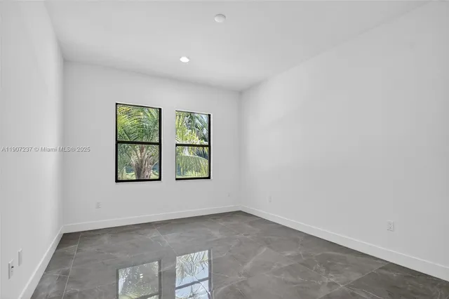 a spacious bedroom with a bed and a couch