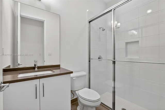 a bedroom with a bed and painting on the wall