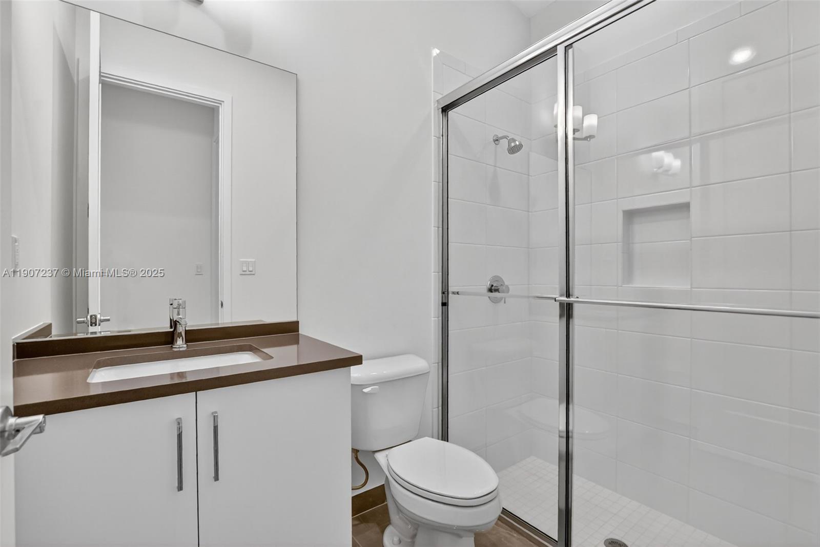 8215 Crystal Downs Avenue, Unit 8215 Boca Raton, FL 33434 - Photo 32 of 95 a bathroom with a sink a toilet and shower