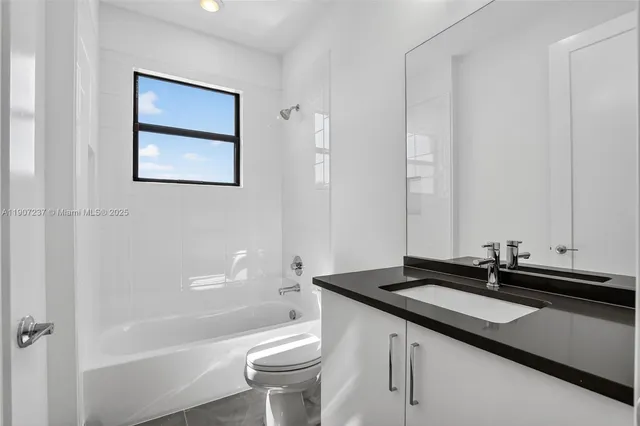 a living room with patio furniture and a floor to ceiling window