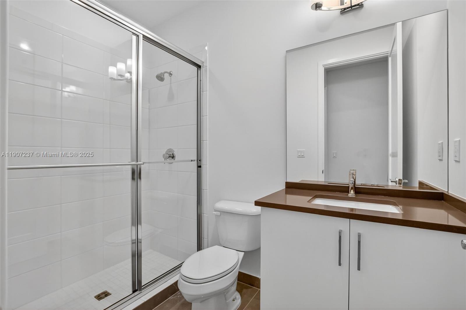 8215 Crystal Downs Avenue, Unit 8215 Boca Raton, FL 33434 - Photo 46 of 95 a bathroom with a sink and a mirror