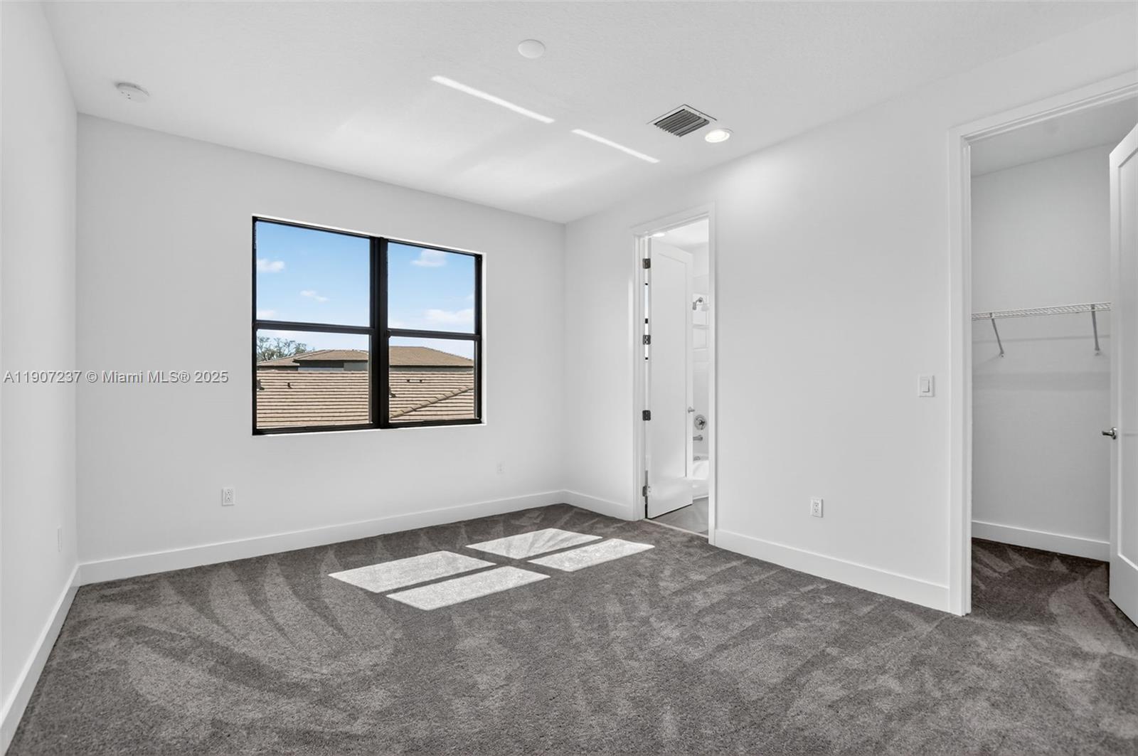 8215 Crystal Downs Avenue, Unit 8215 Boca Raton, FL 33434 - Photo 47 of 95 an empty room with windows and closet