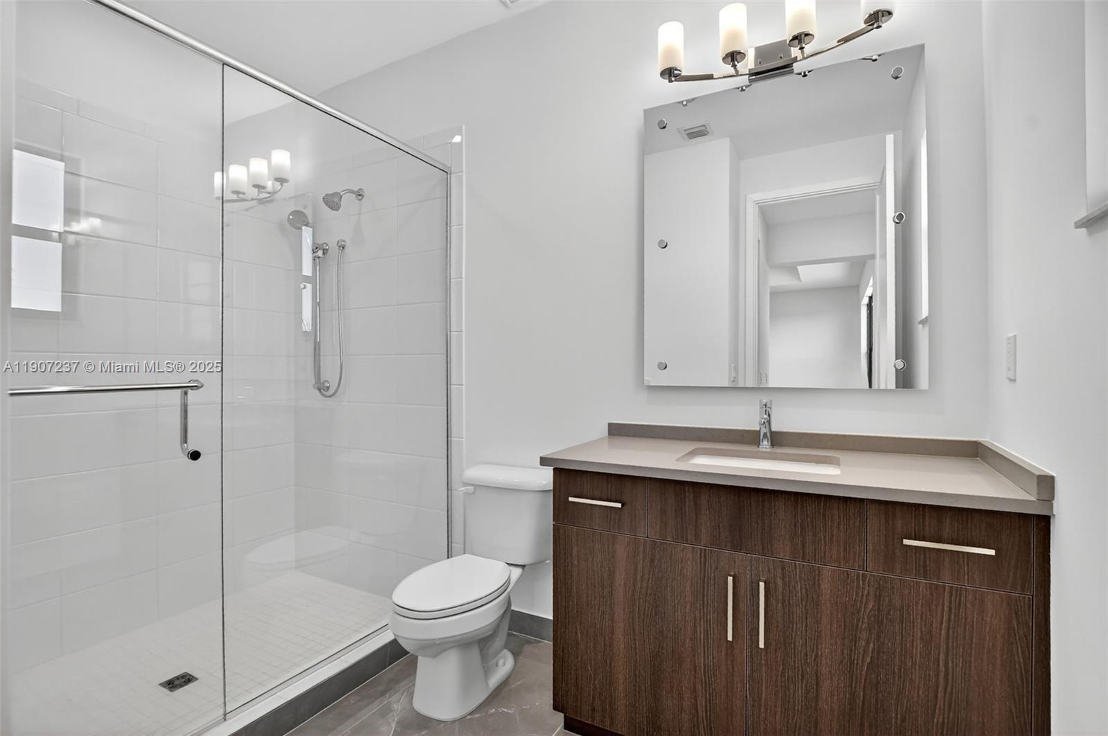 8215 Crystal Downs Avenue, Unit 8215 Boca Raton, FL 33434 - Photo 54 of 95 a bathroom with a granite countertop sink toilet and shower