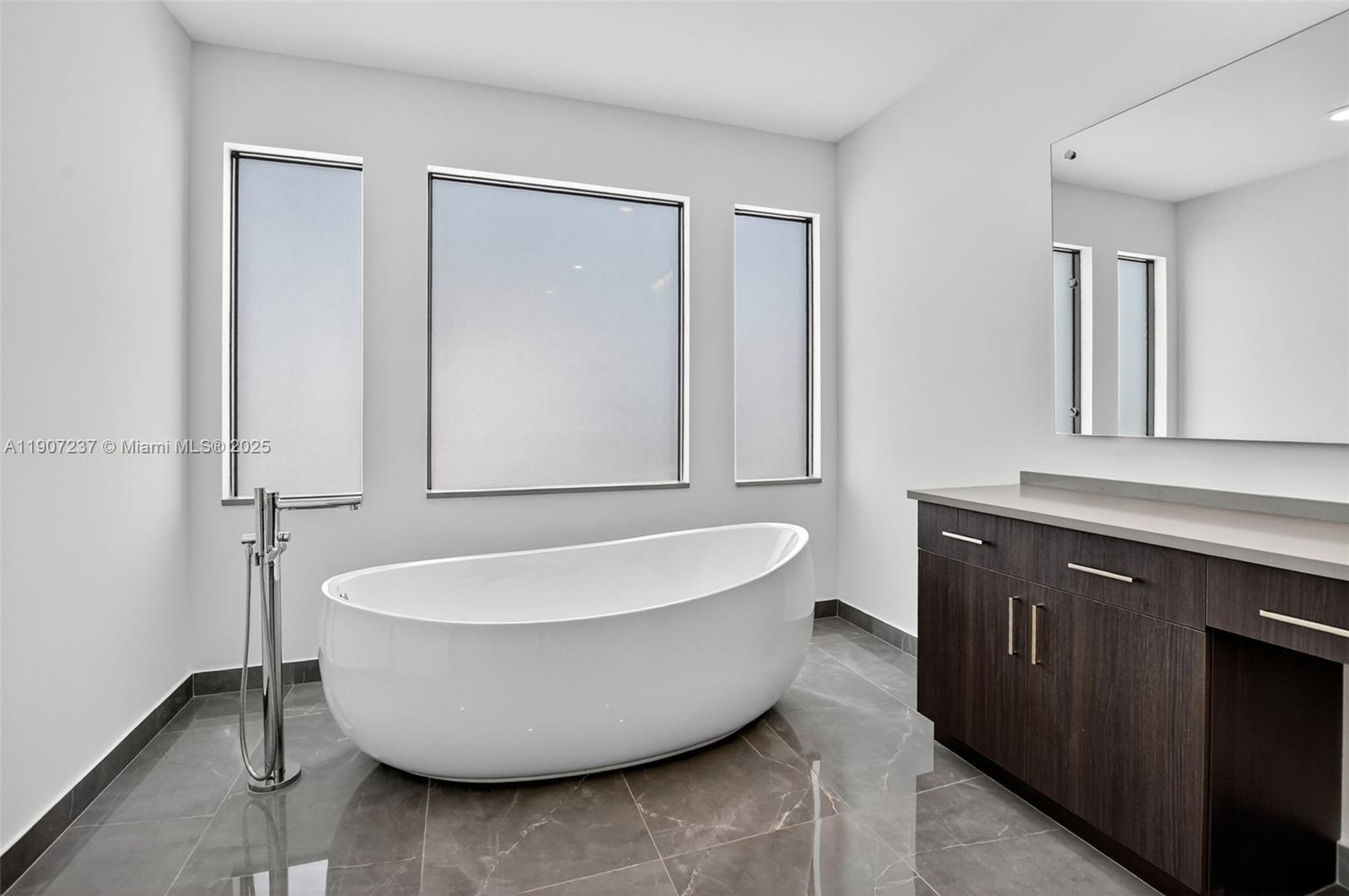 8215 Crystal Downs Avenue, Unit 8215 Boca Raton, FL 33434 - Photo 59 of 95 a spacious bathroom with a bathtub and shower
