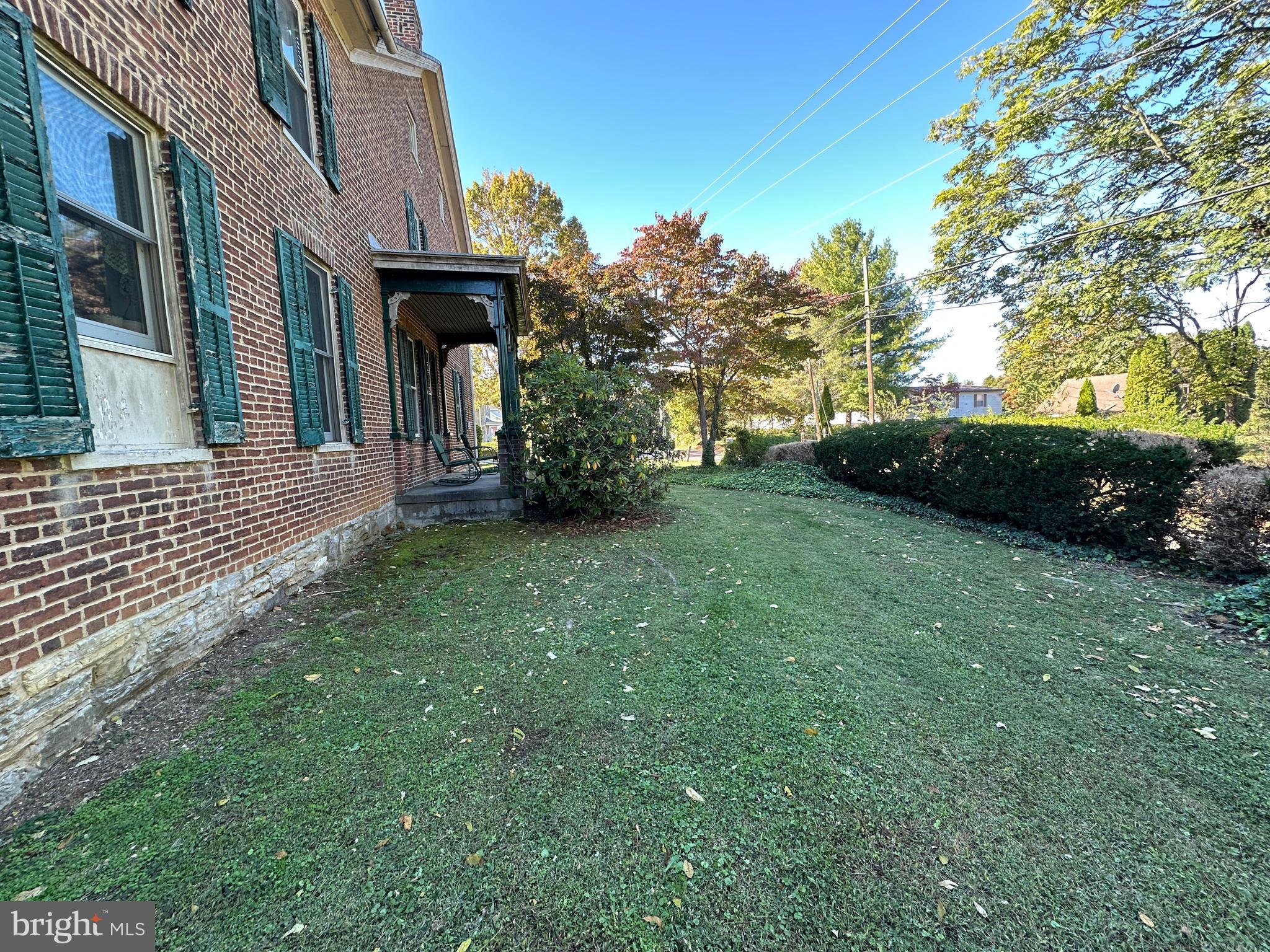 12429 Angle Drive Clear Spring, MD 21722 - Photo 26 of 129 a view of a car park in front of a brick house with a large tree