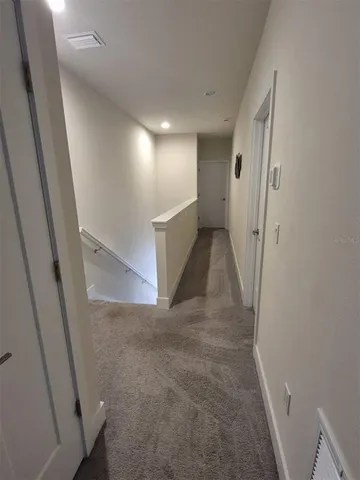 a view of a hallway view with staircase