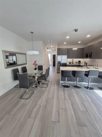 a living room with furniture and kitchen view