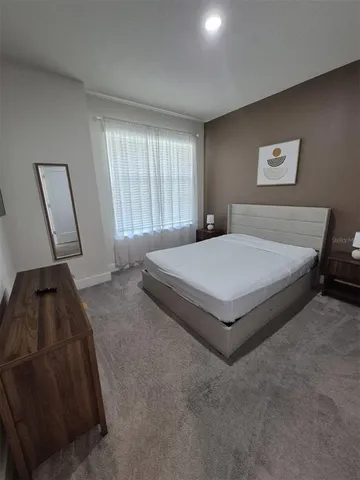 a bedroom with a bed and a mirror