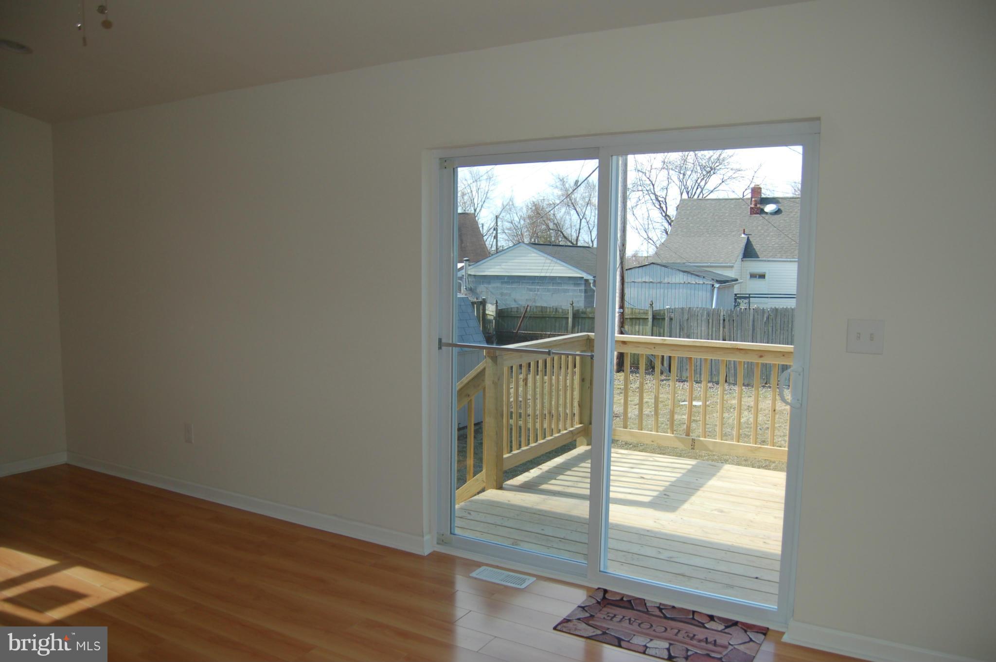 2 Plateau Road Baltimore, MD 21221 - Photo 14 of 28 an empty room with wooden floor and windows